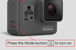 gopro with arrow pointing to power button