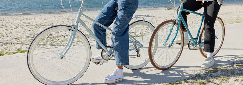 Girl and guy riding Retrospec Kinney on beach bike path