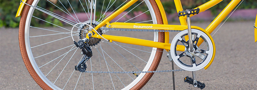 Closeup of yellow Retrospec Beaumont Step Through bike 