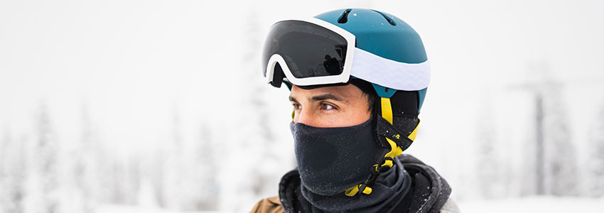 Guy looking to the left, wearing Retrospec Comstock Snow Helmet in snowy area