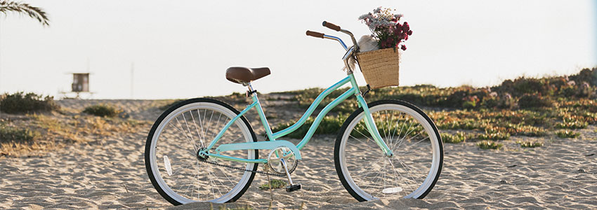 Retrospec Chatham Beach Cruiser on beach with cane basket