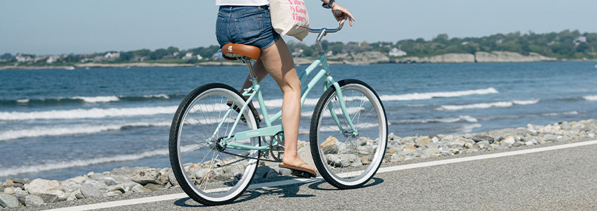 Girl riding Retrospec Chatham Beach Cruiser Bike down beach road