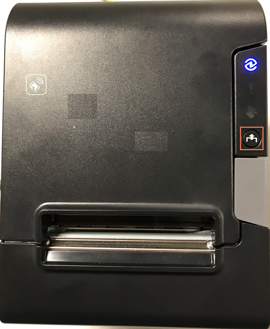 Photo of the printer with the feed button highlighted