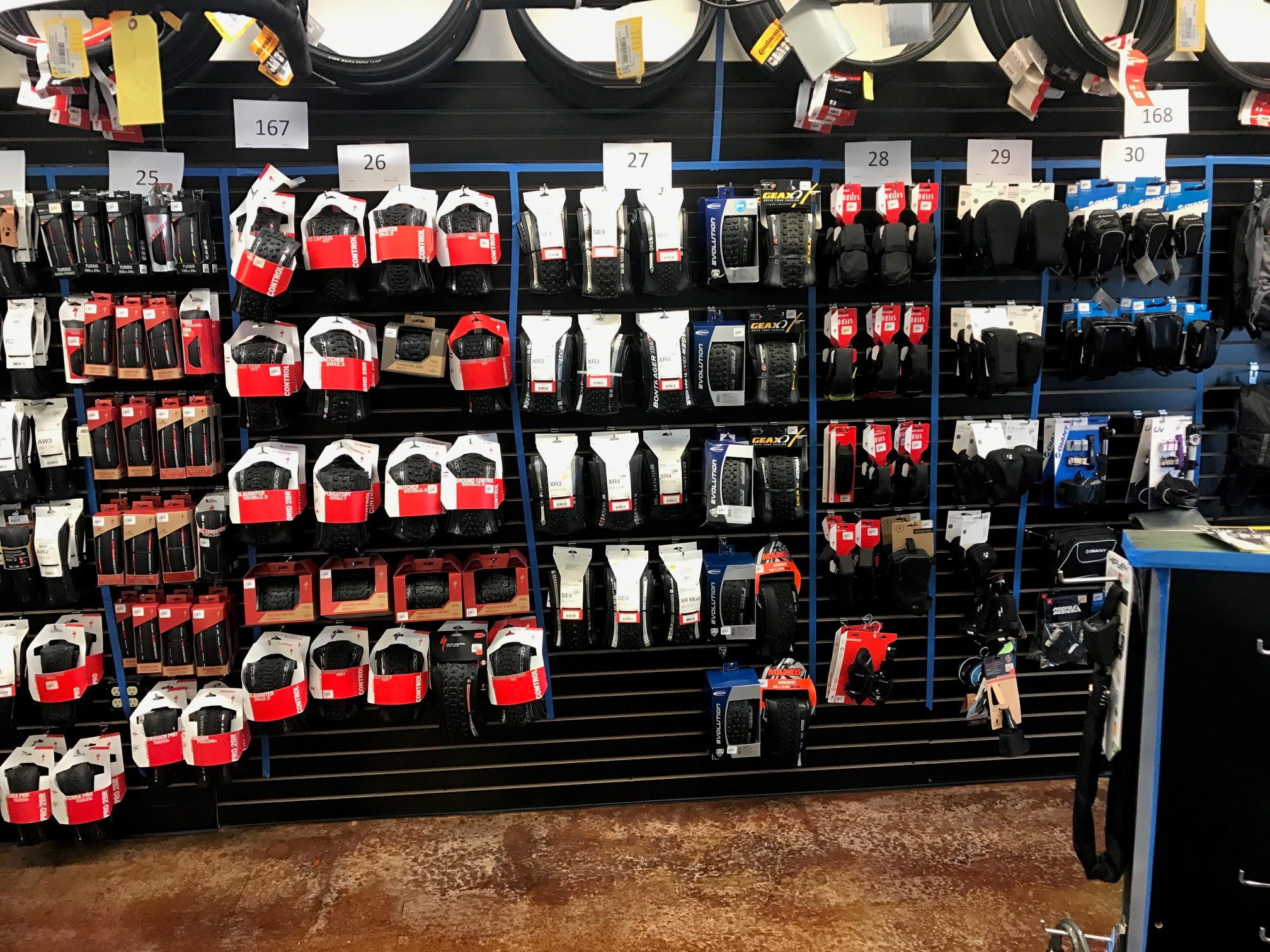 Photo of a store display wall with numbers 25 - 30 above each section of product