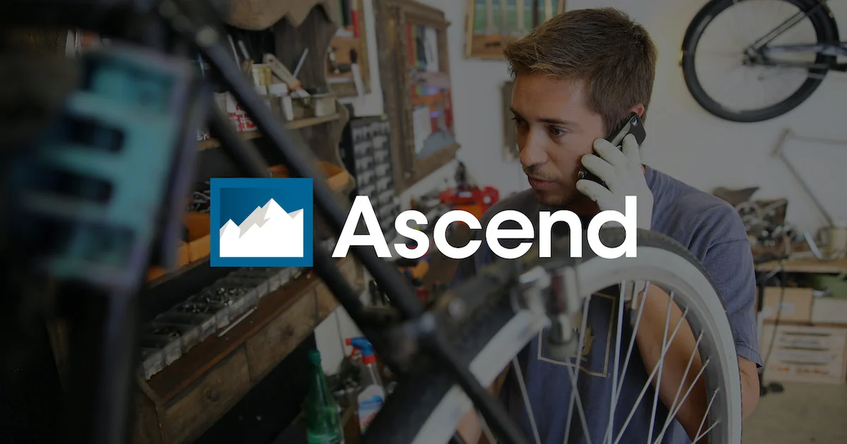 Photo of a bike shop employee on the phone with the Ascend logo over top of the photo