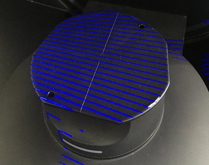 A black and blue circular object with blue lines

Description automatically generated